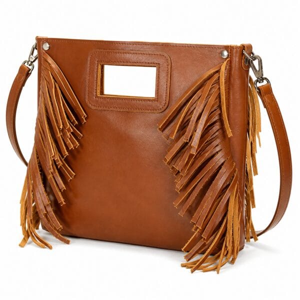 Brown leather fringe bag with a flat rectangular body, hand-cut fringe down both side panels, an integrated cutout handle and a long detachable strap.