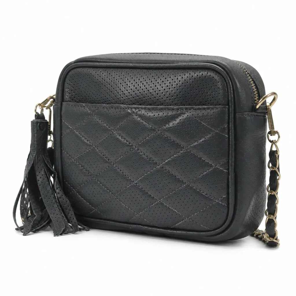 Diamond-quilted black leather camera bag with a gold-tone chain strap woven with leather, a leather tassel and a top-zip closure.