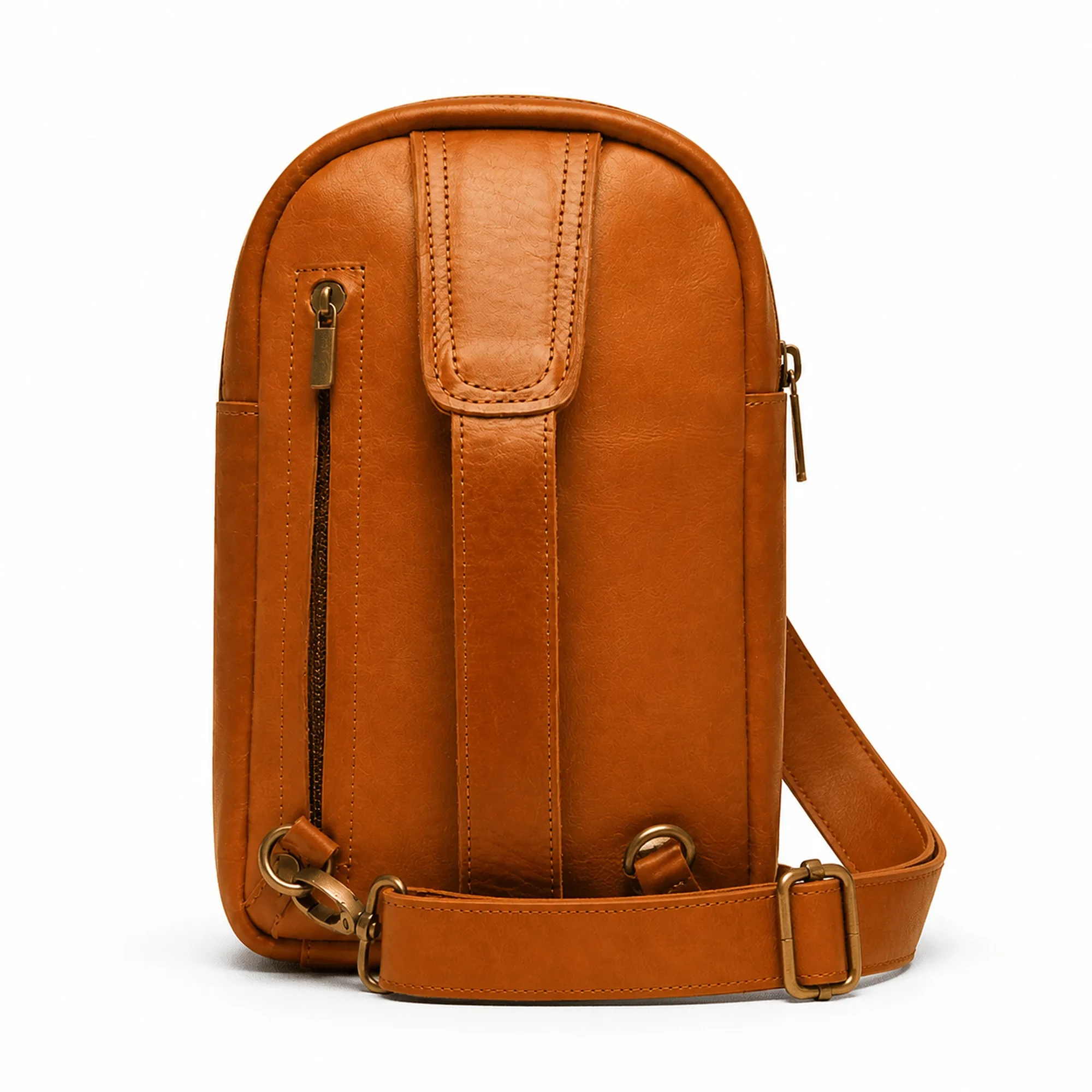 Back of the cognac leather sling bag with the strap attached, showing the flat panel that sits against the body.