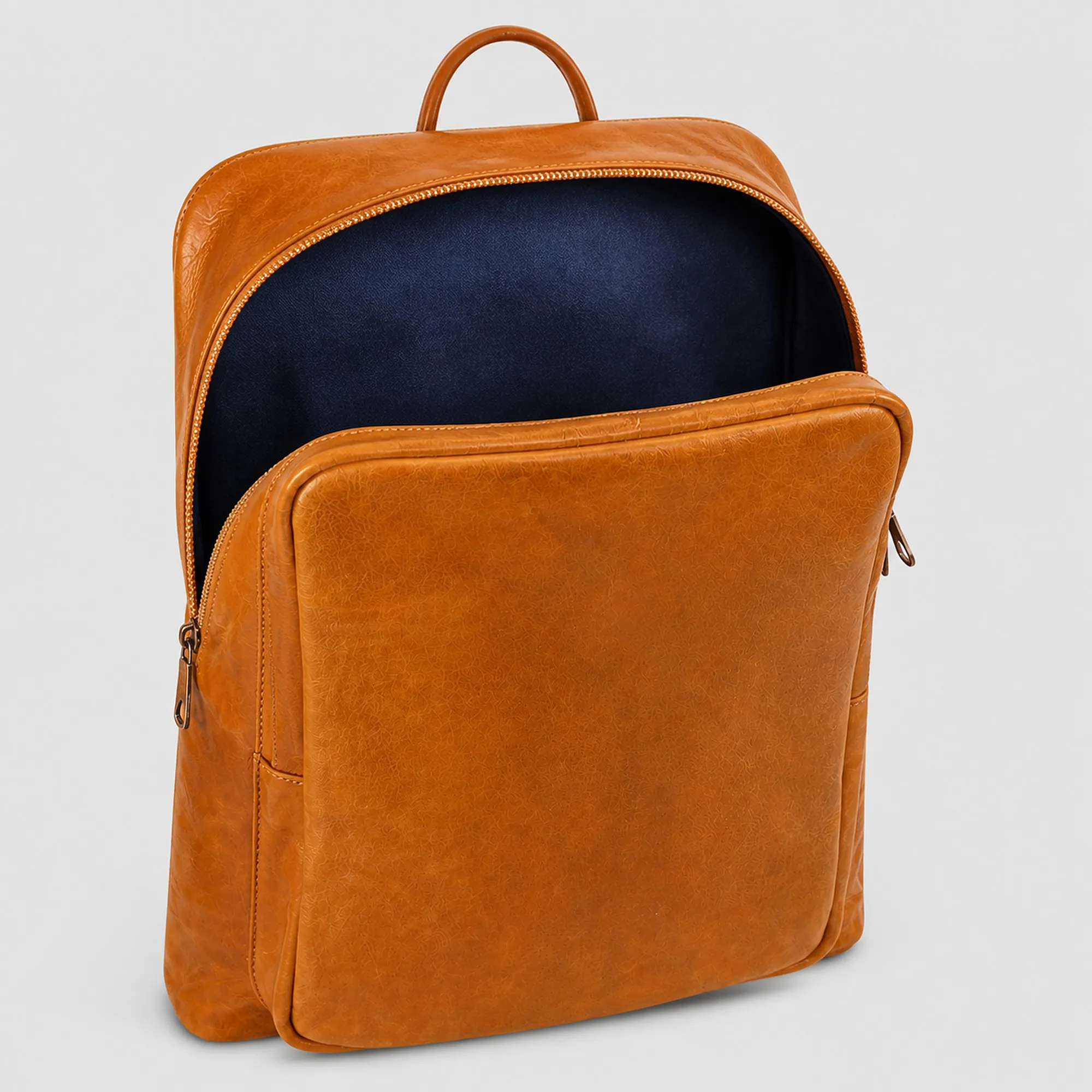 Inside the leather backpack: a navy fabric lining and the padded sleeve sized for 13 to 14 inch laptops and tablets.