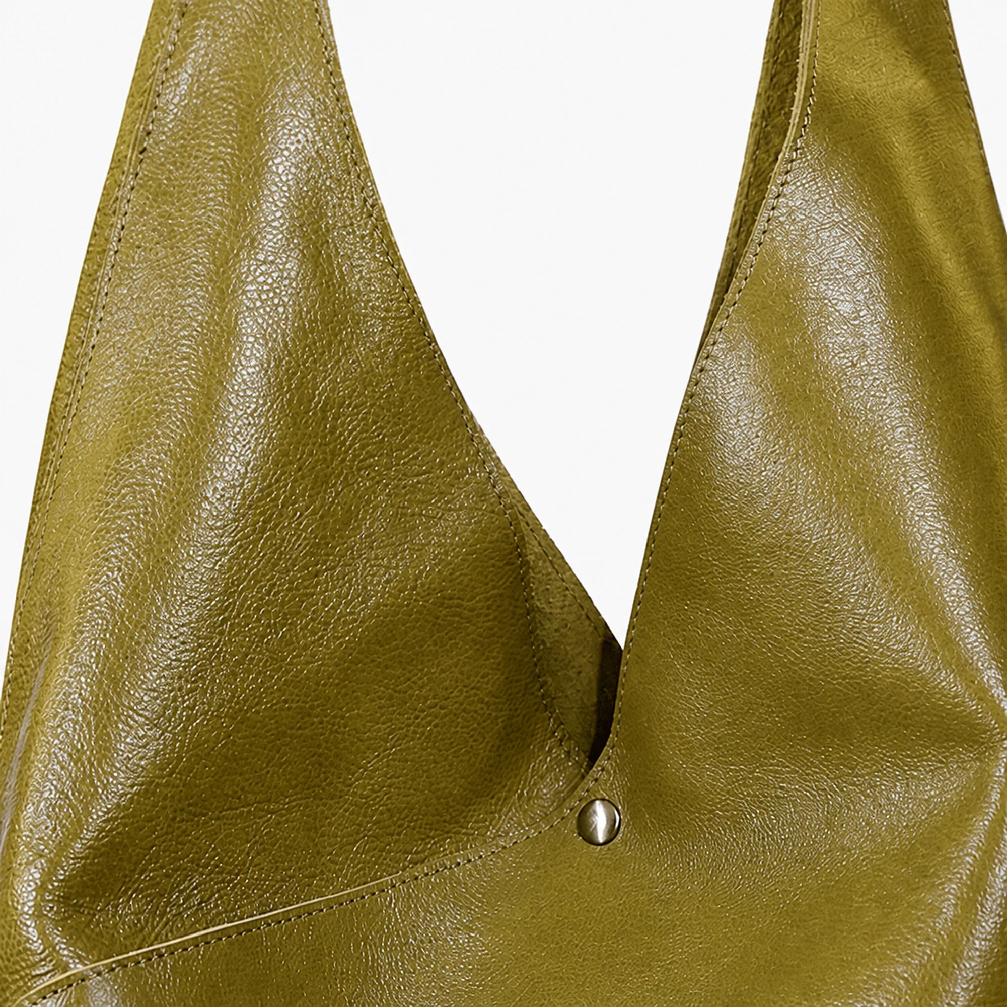 Supplier close view of the semi-glossy surface and the natural grain of the olive leather.